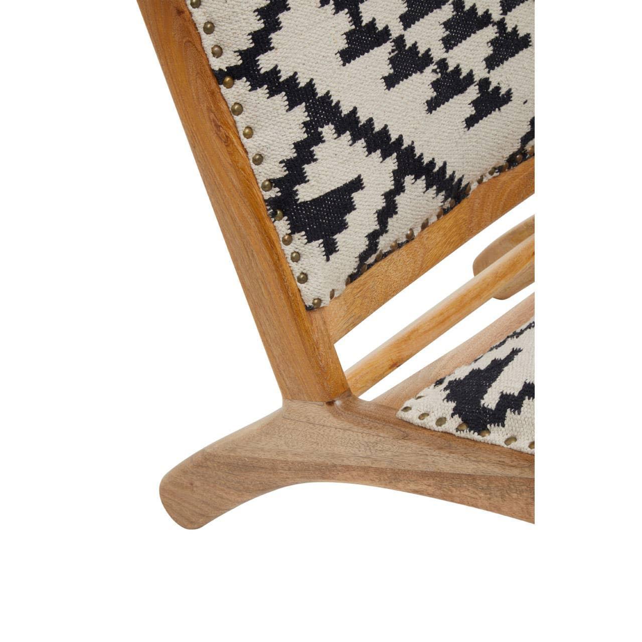 Wooden chair leg with geometric patterned fabric upholstery and brass stud detail