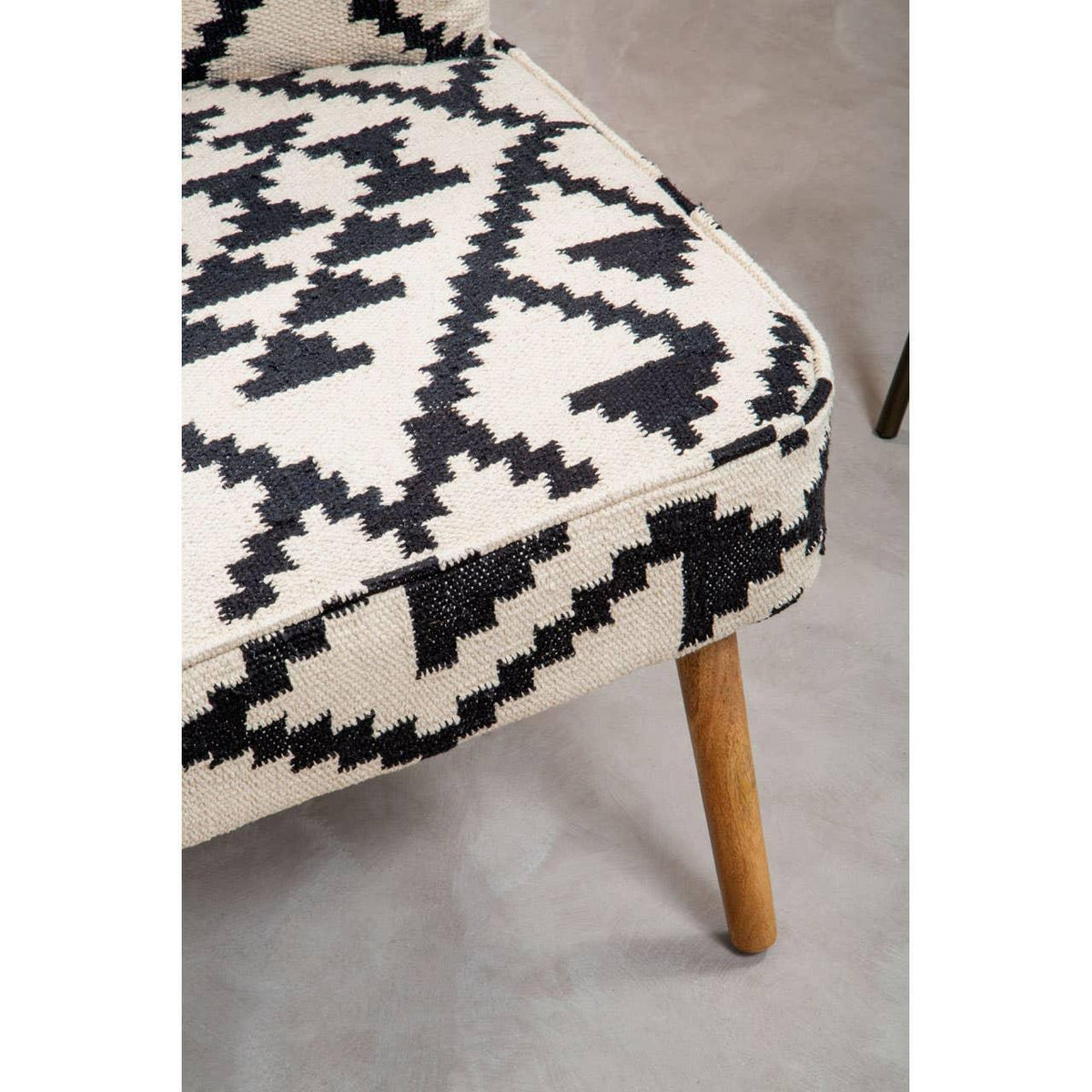Patterned accent chair with geometric black and cream upholstery and wooden legs