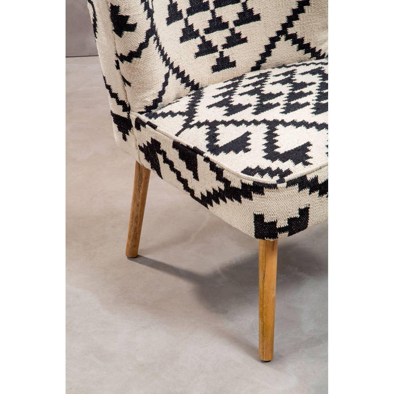 Modern accent chair with black and white geometric upholstery and wooden legs