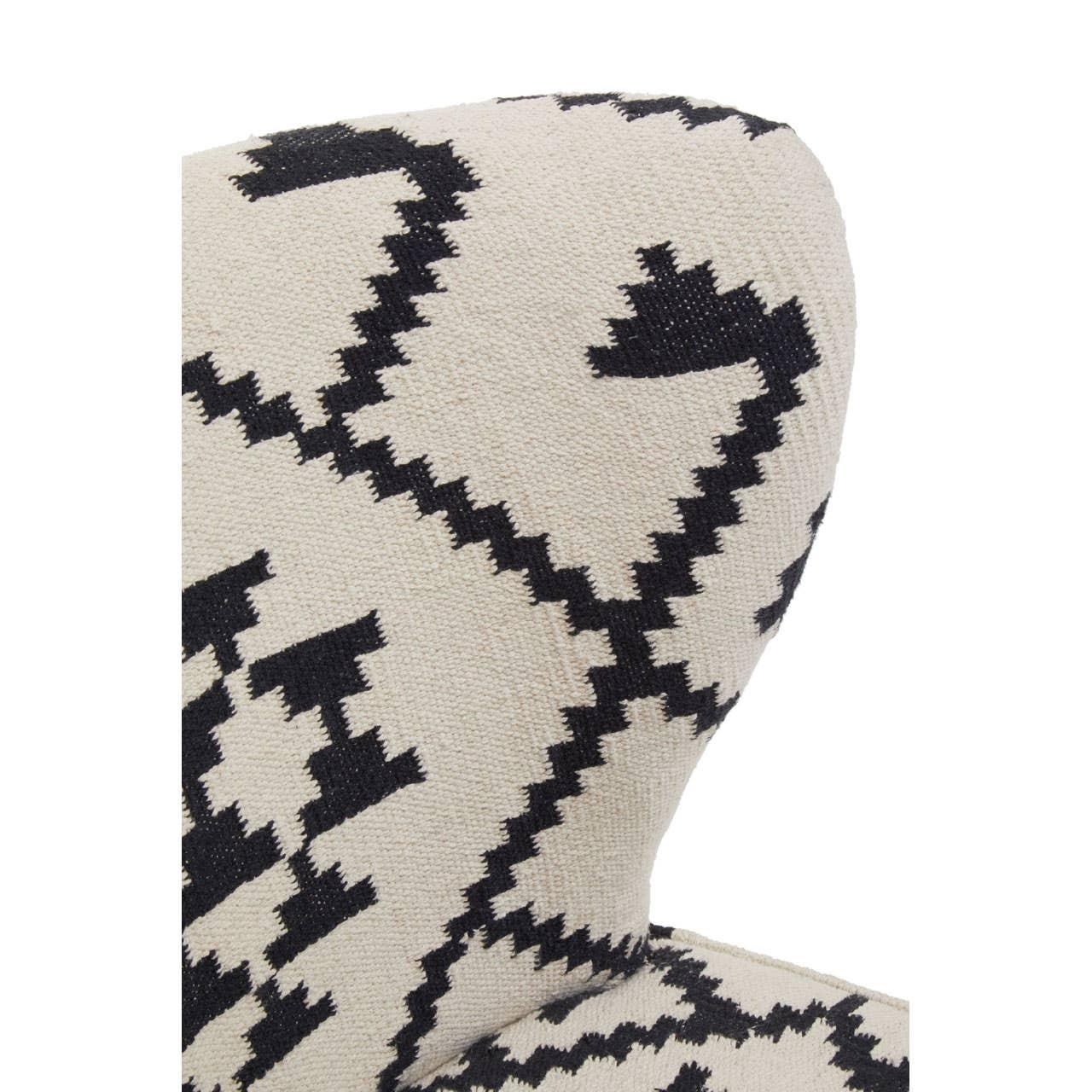 Closeup of upholstered chair with black and white geometric fabric pattern