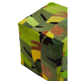 A colorful pouffe featuring a botanical pattern with shades of green, yellow, and brown, showcasing a modern design suitable for home decor. The pouffe has a cube shape and is upholstered in leather, providing a stylish and functional seating option
