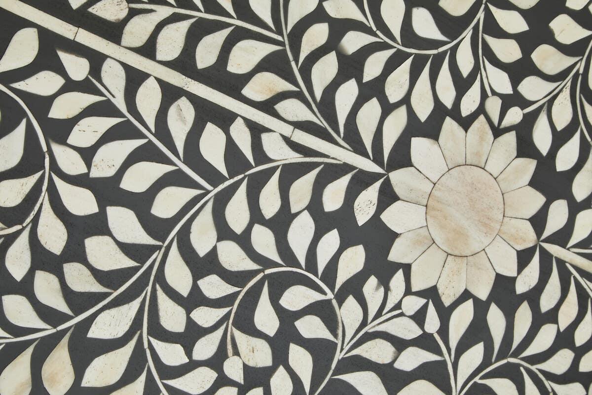 bone inlay furniture pattern with white floral and leaf design on black background