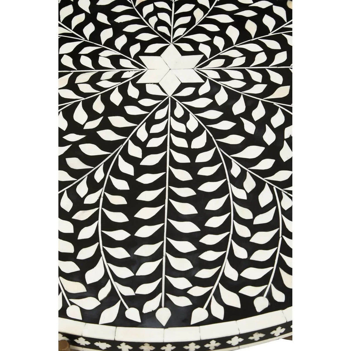 Black and white bone inlay tabletop with leaf pattern and geometric center detail
