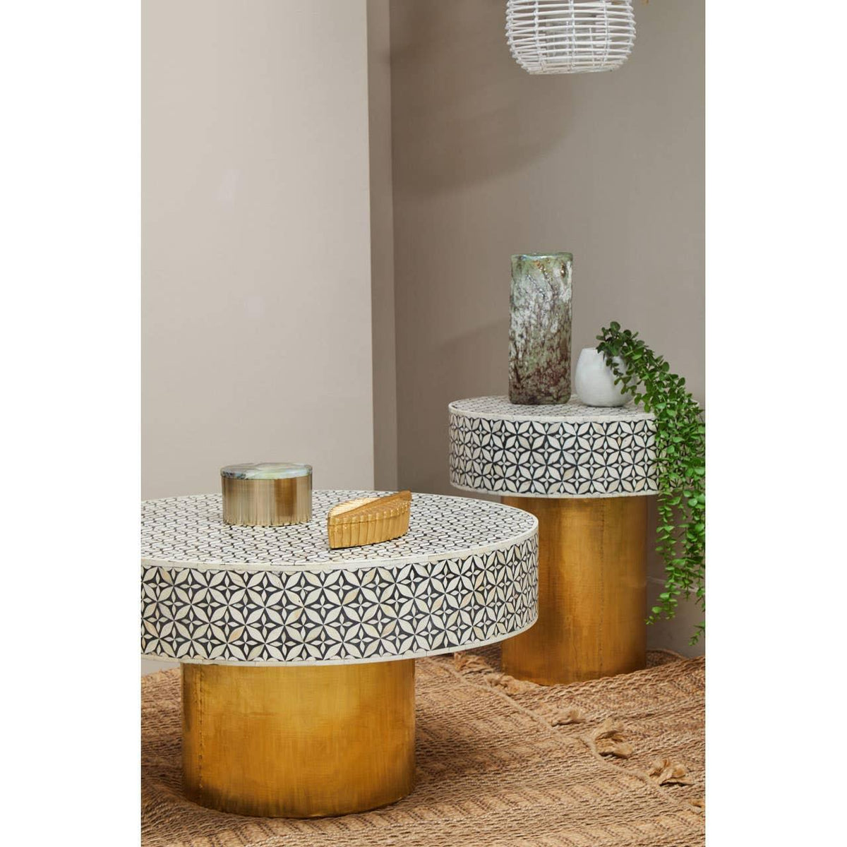 Round coffee tables with geometric mosaic tops and gold bases, styled with decorative items