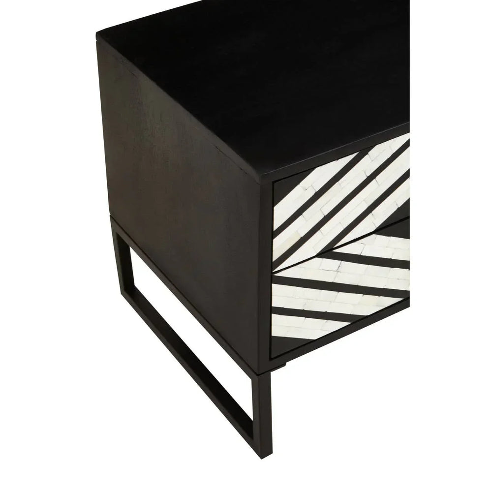 Black wood side table with geometric white inlay on front drawer, angled detail view