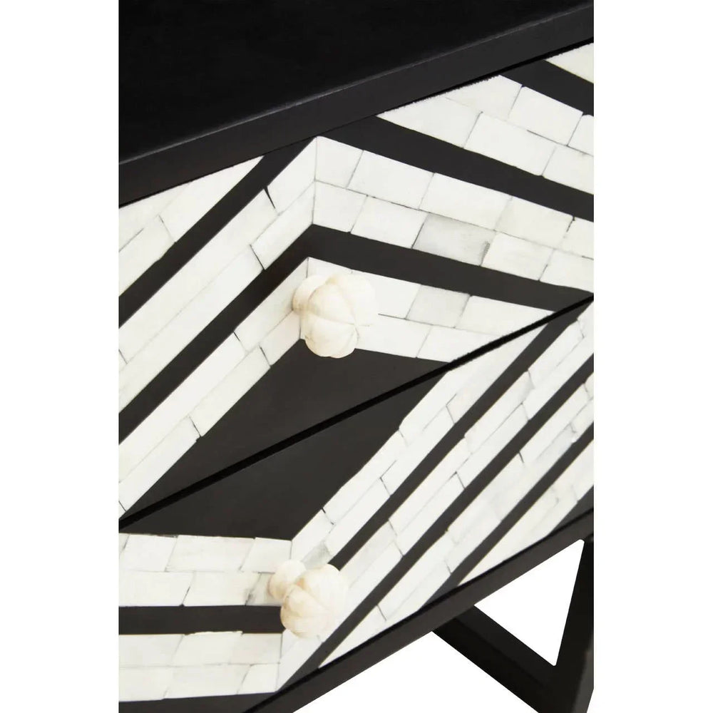 Black and white striped chest of drawers with geometric pattern and round handles