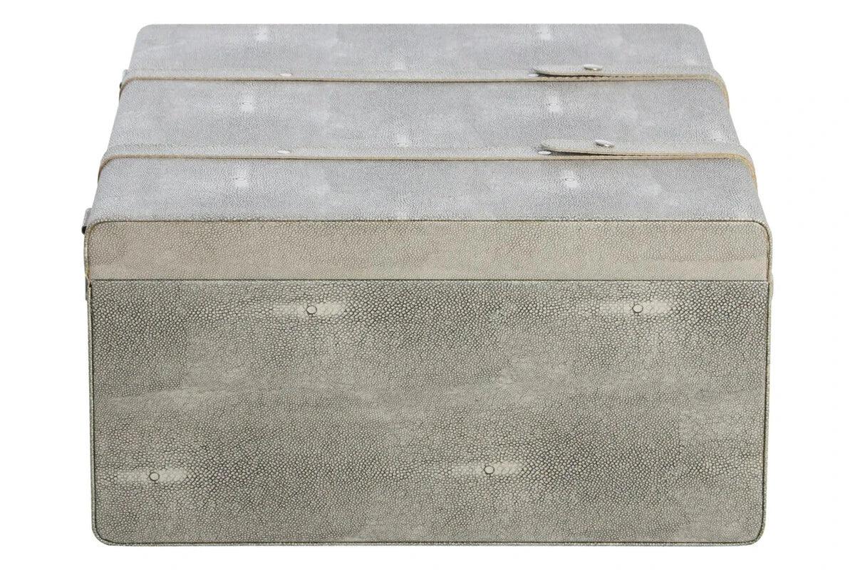 Grey faux shagreen storage trunk with two straps and textured finish, front view