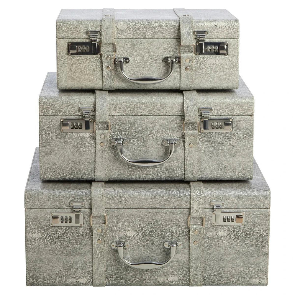 Set of three grey storage trunks with silver handles and combination locks, stacked front view