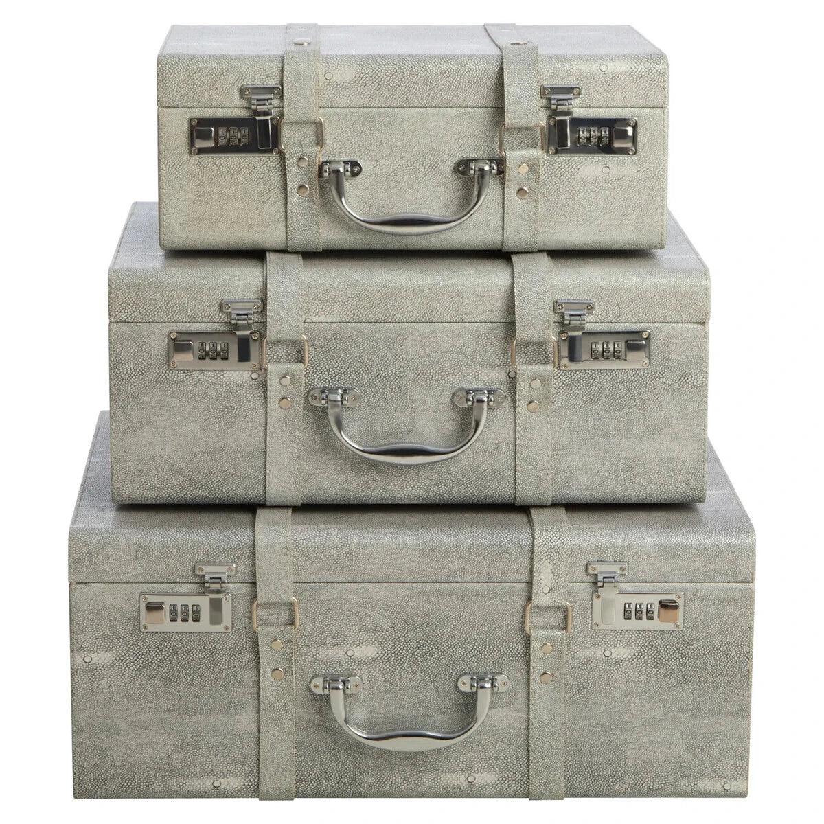 Set of three grey storage trunks with silver handles and combination locks, stacked front view