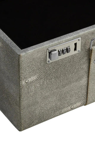 Textured grey storage trunk with silver combination lock and metal hardware close-up