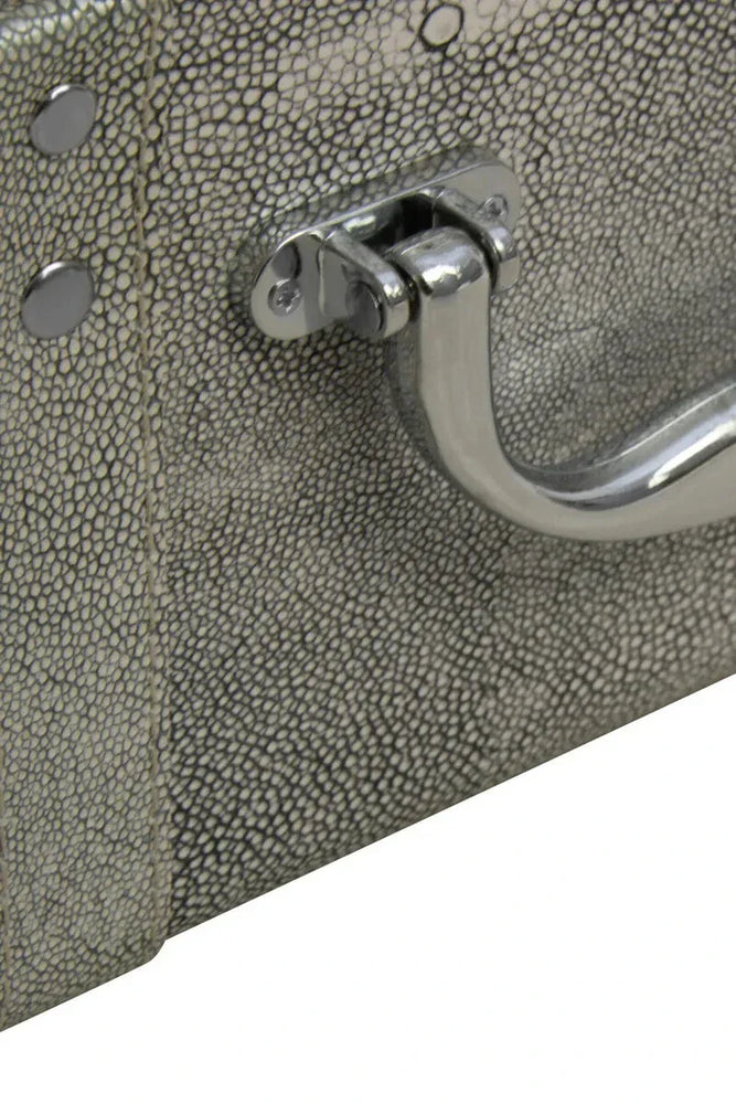 Close-up of faux shagreen storage trunk with textured grey finish and chrome handle