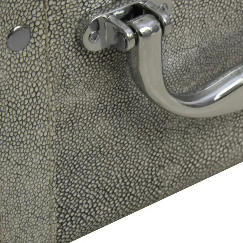Close-up of faux shagreen storage trunk with textured grey finish and chrome handle