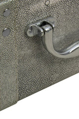 Close-up of faux shagreen storage trunk with textured grey finish and chrome handle