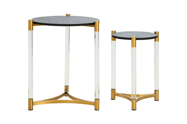 Set of two round side tables with black tops, clear legs, and gold metal accents