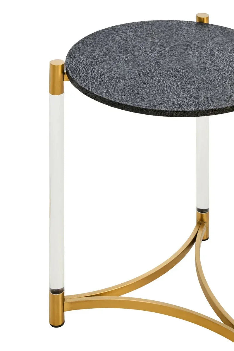 Round side table with textured black top, gold base, and clear acrylic legs