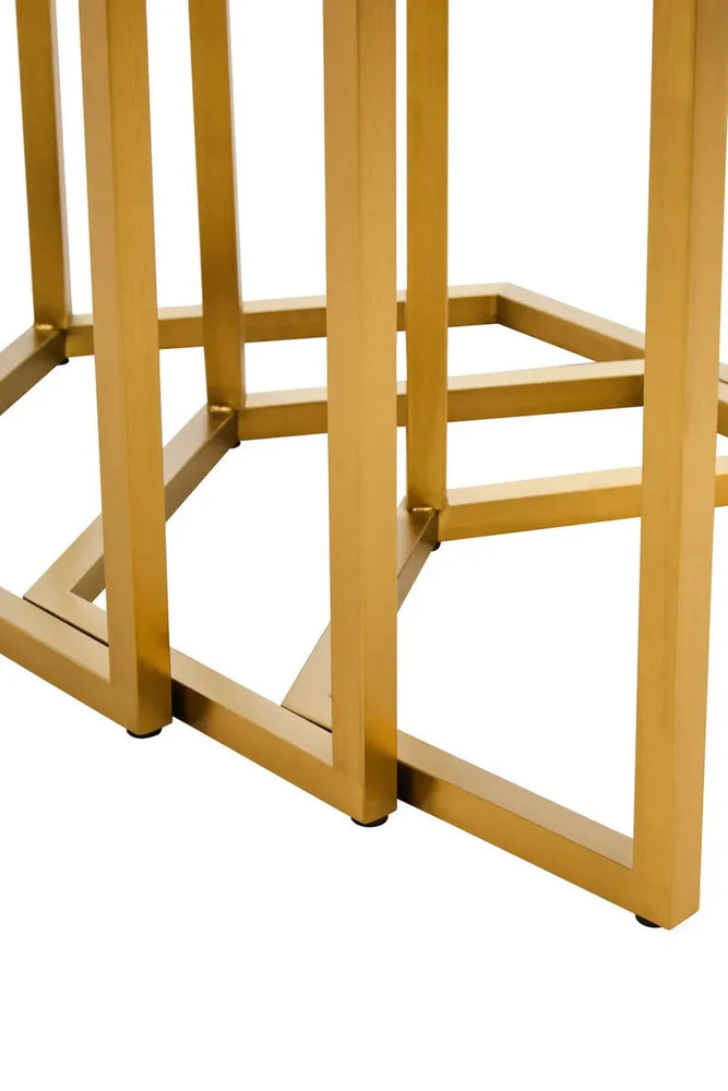 Gold metal table legs with geometric design on white background