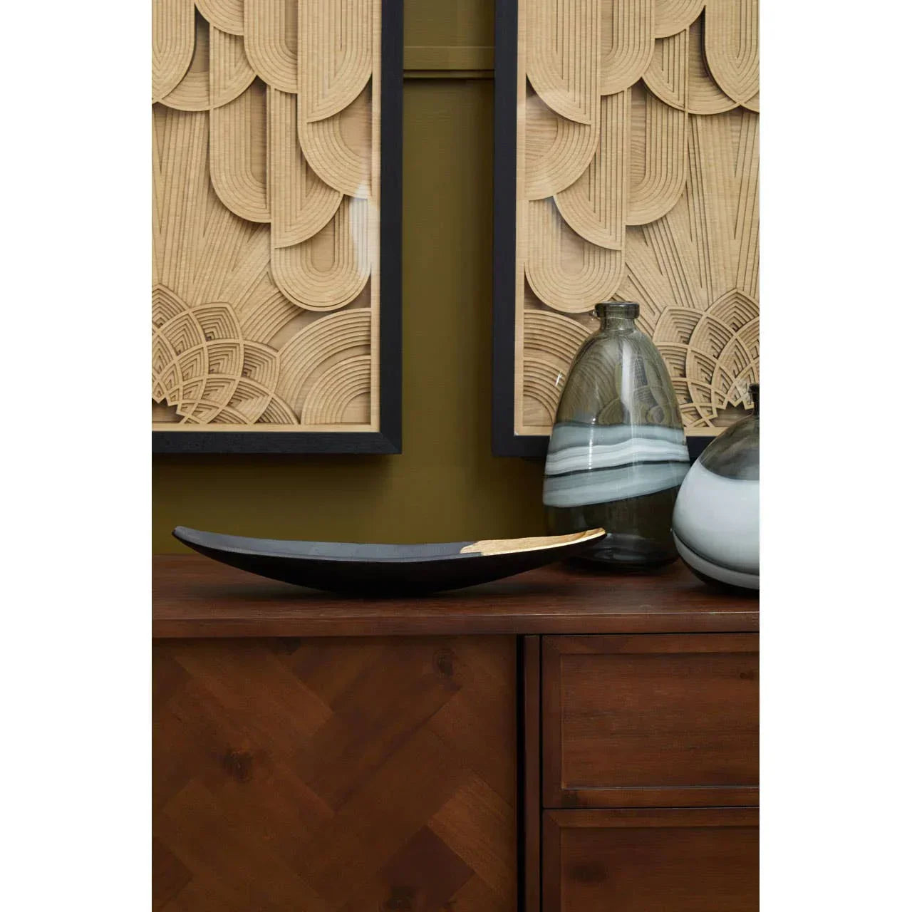 Dark wood sideboard with decorative vases and modern geometric wall art