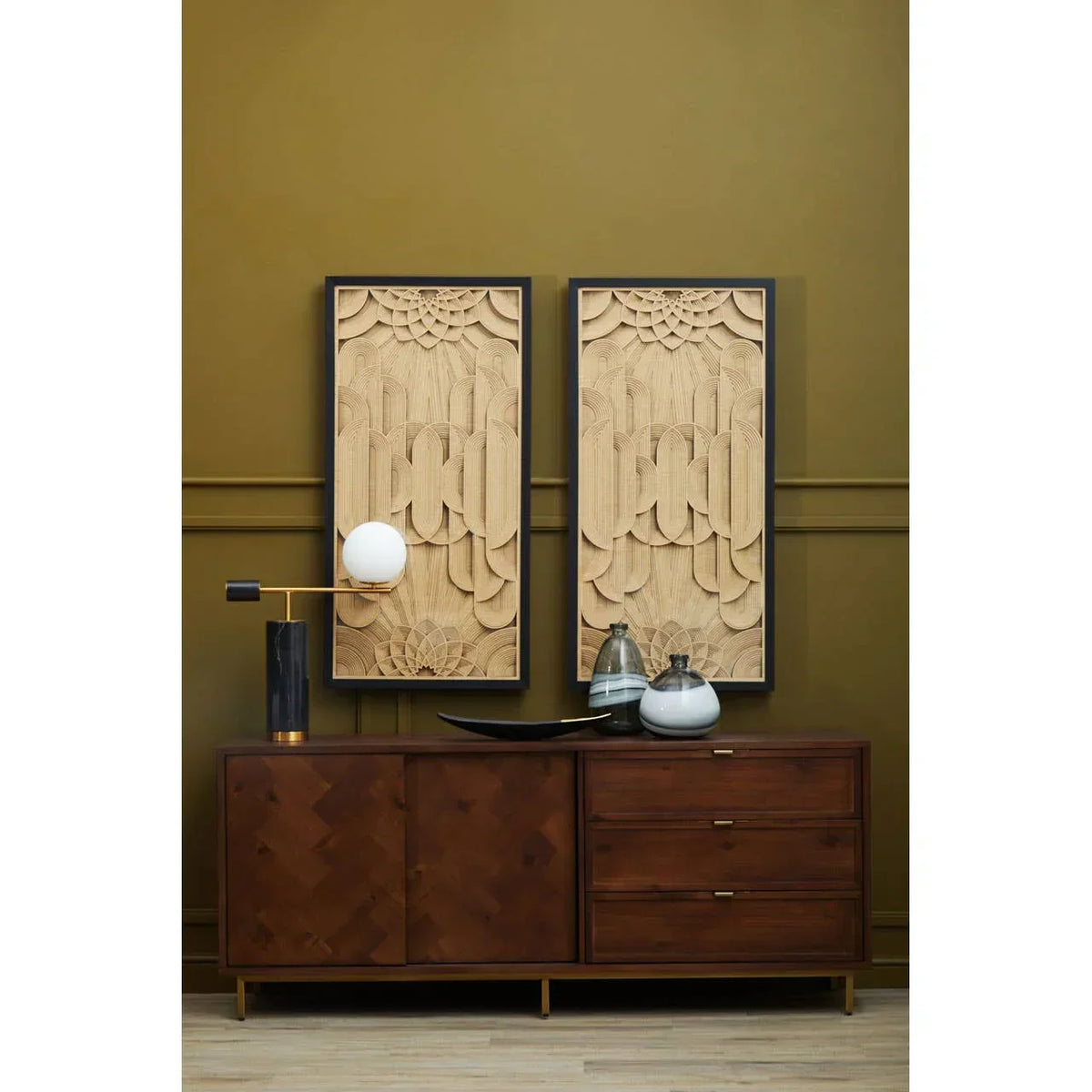 Walnut sideboard with brass handles, decorative vases and wood wall art in modern living room