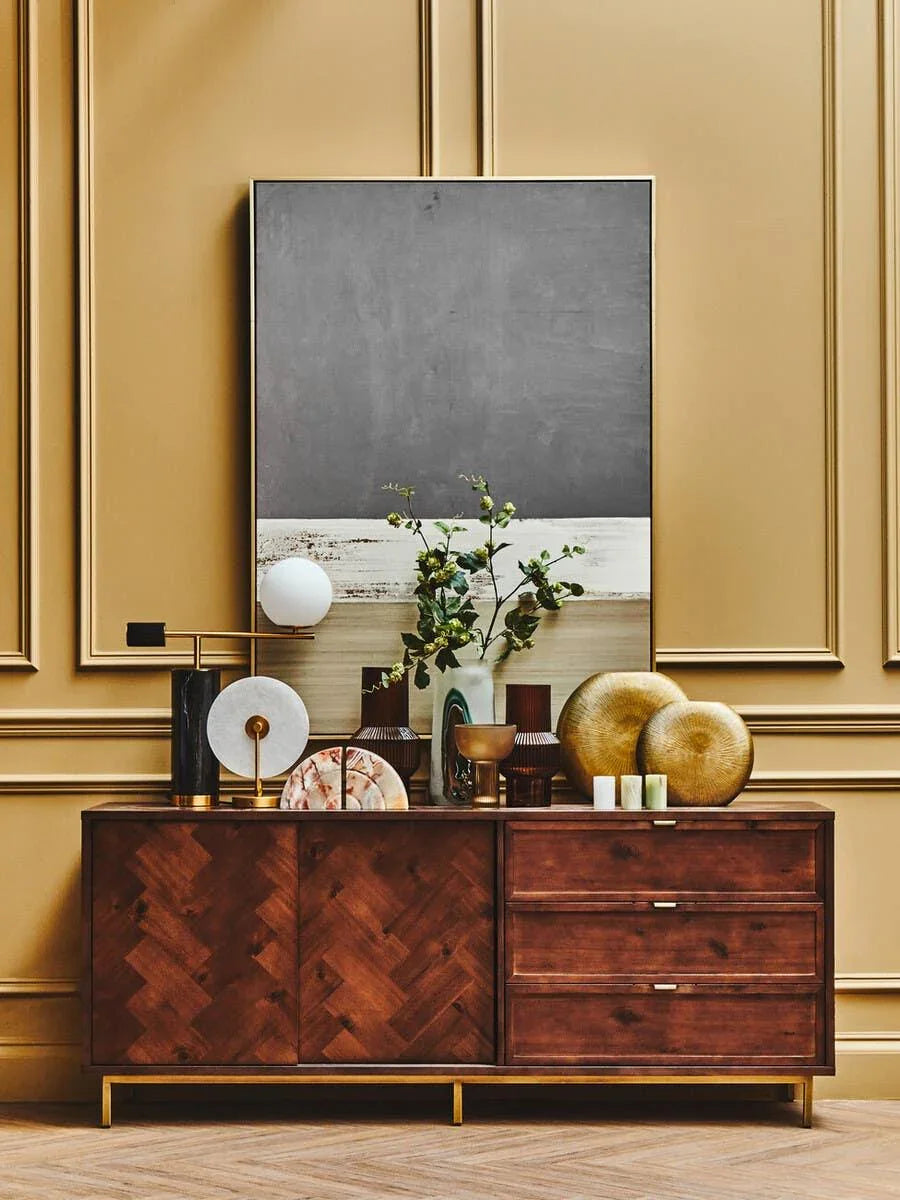 Walnut sideboard with gold base, decorative vases and sculpture in a modern living room