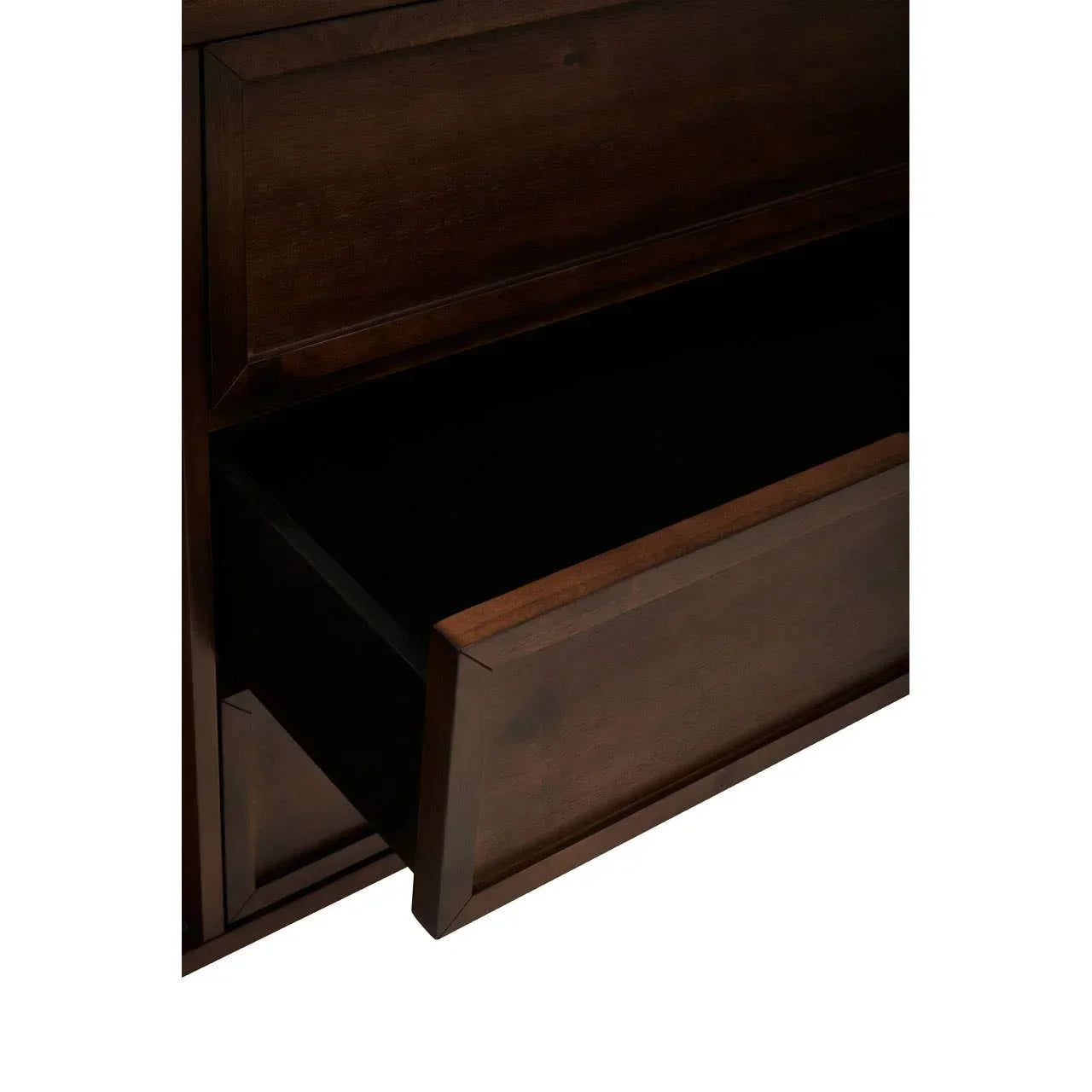 Dark wood chest of drawers with one drawer partially open, showing panelled front detail