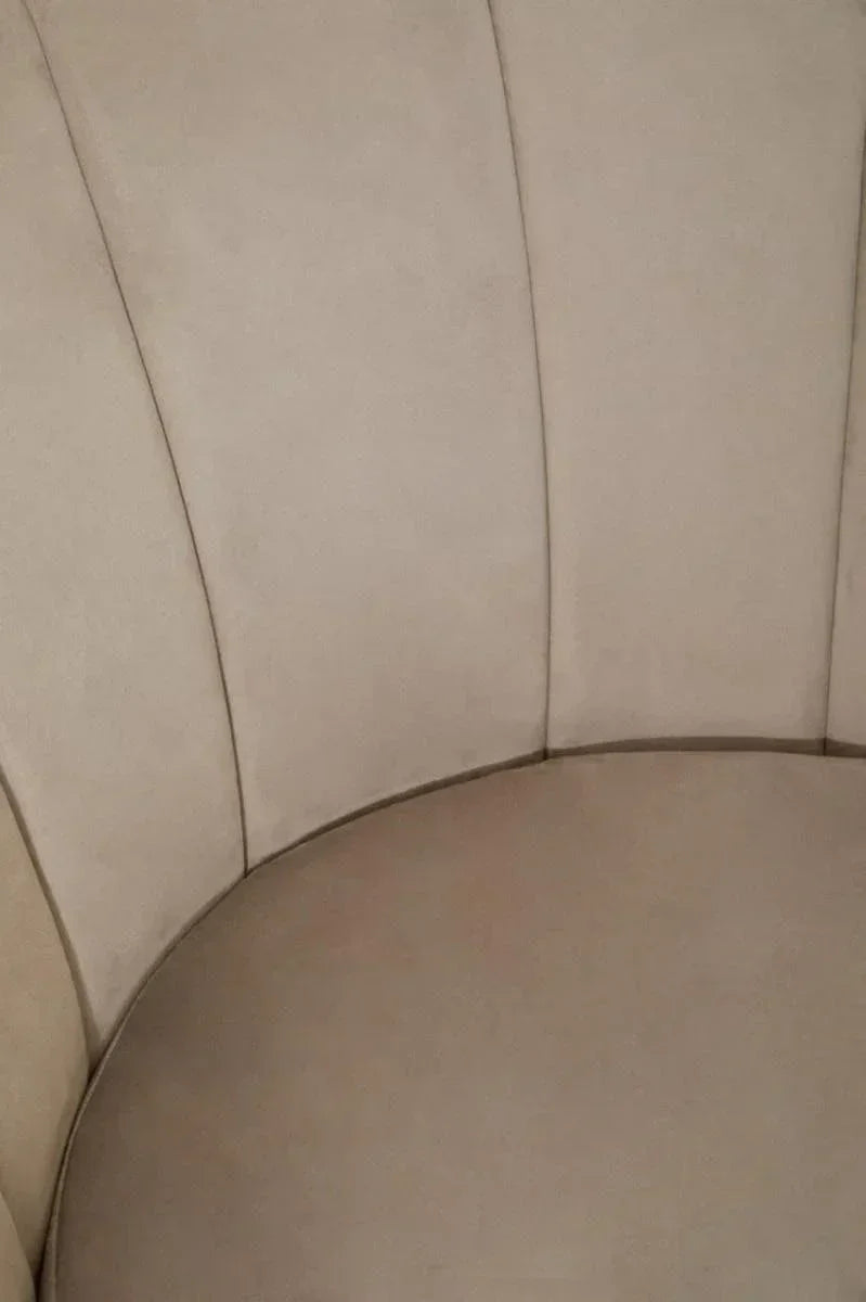 Beige fabric armchair with vertical stitched backrest detail, close-up view