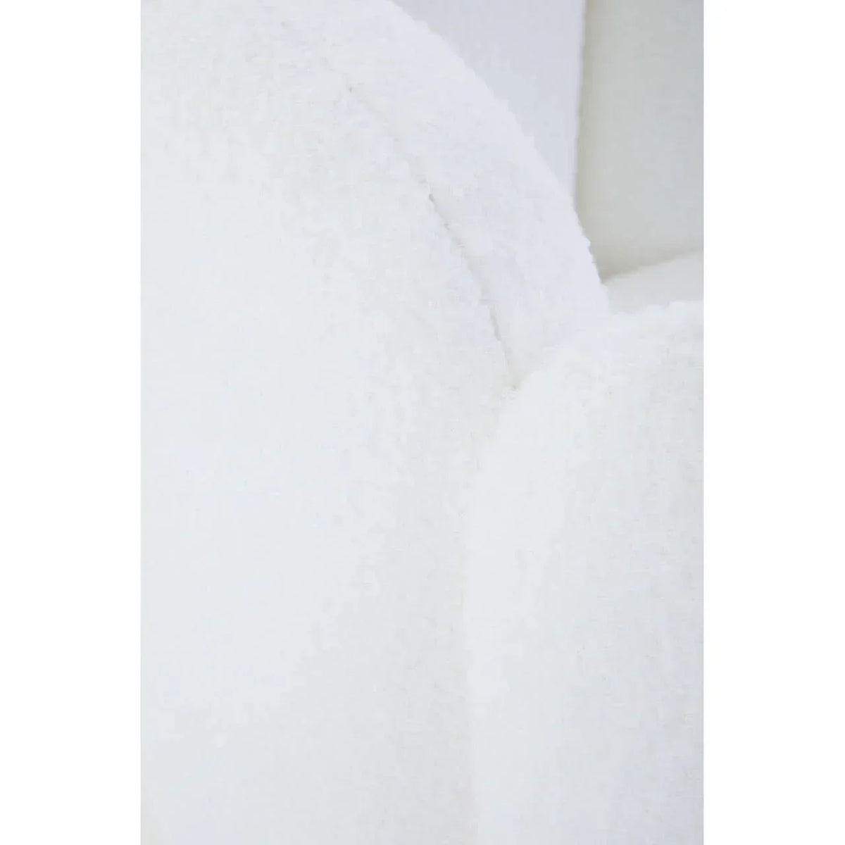 Close up of white boucle fabric armchair with curved backrest