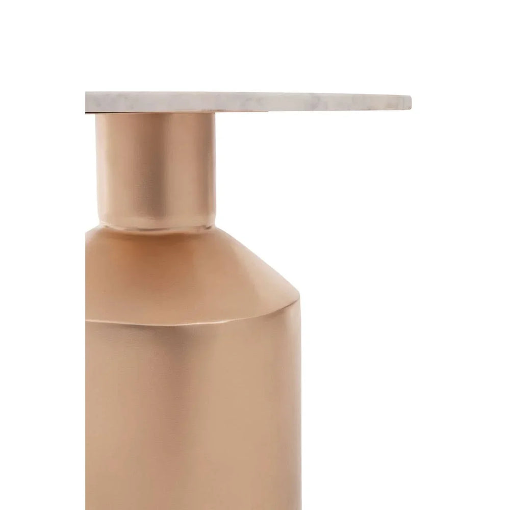 Close-up of gold metal side table base with white marble tabletop