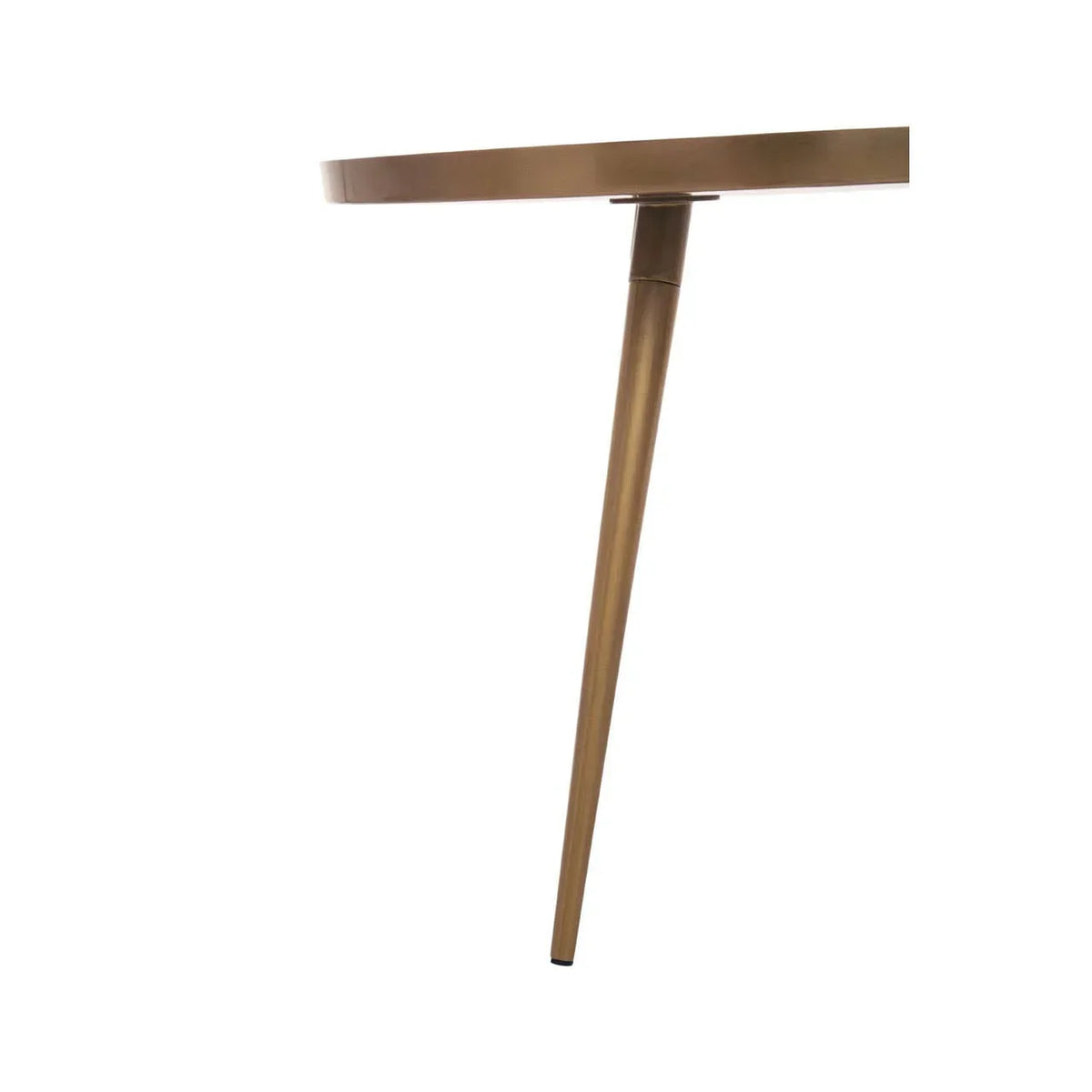 Close-up of round brass table top and angled metal table leg