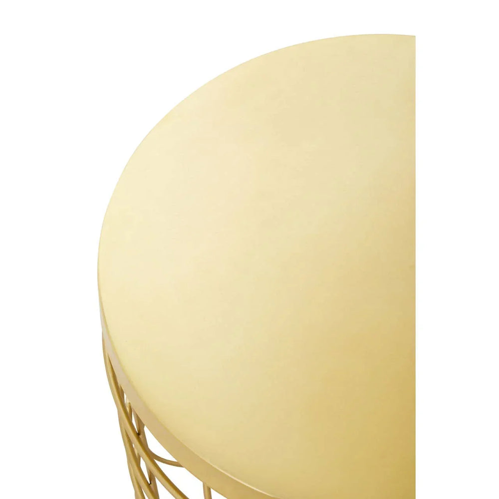 Round gold metal side table with smooth top and wire base, close-up view