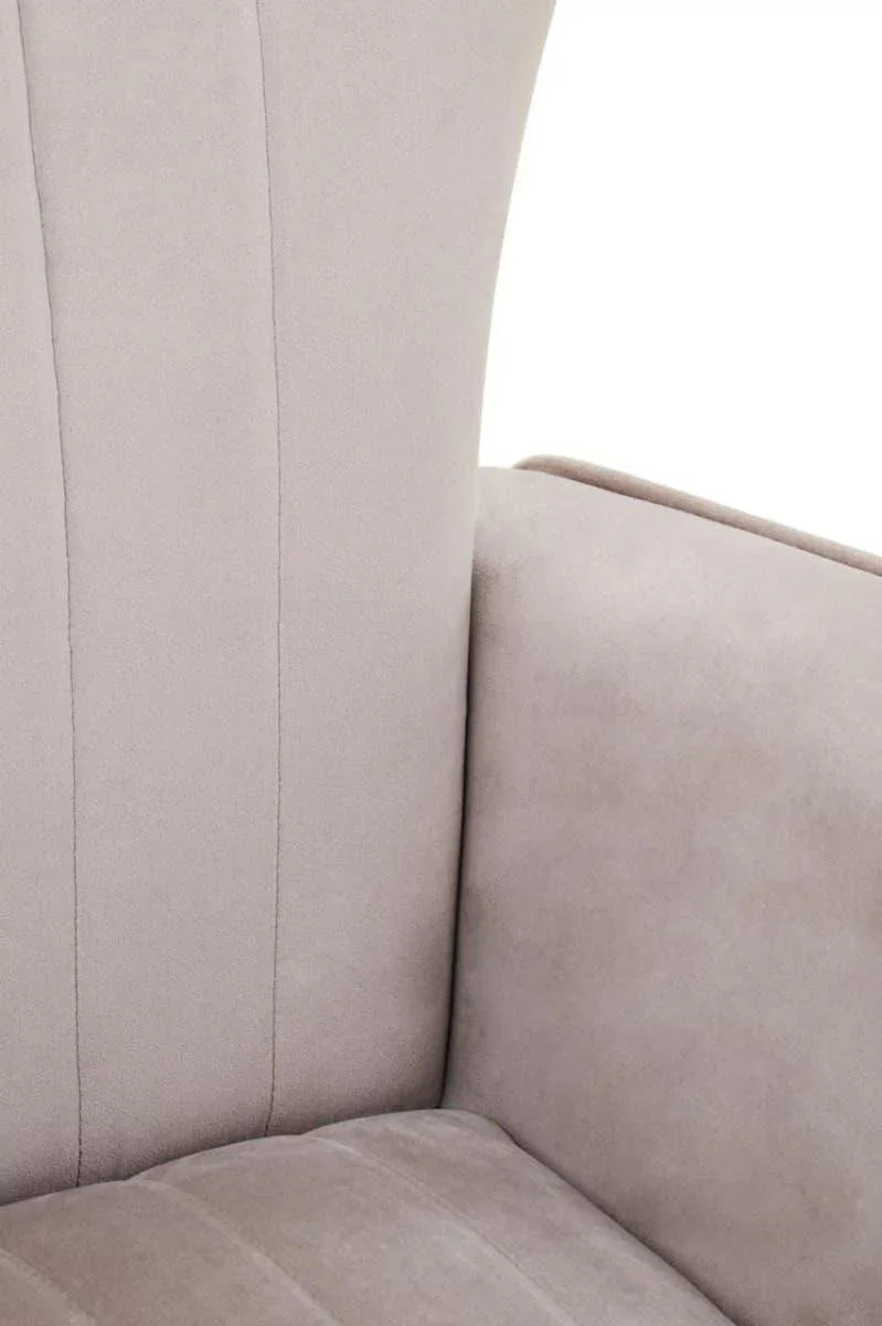 Close up of light grey fabric armchair with vertical stitching on cushioned backrest