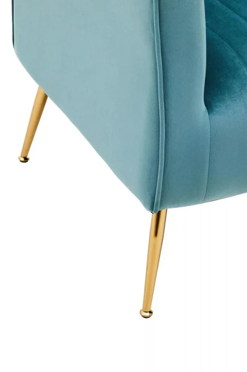 Velvet accent chair corner in teal with slim gold metal legs, close-up view