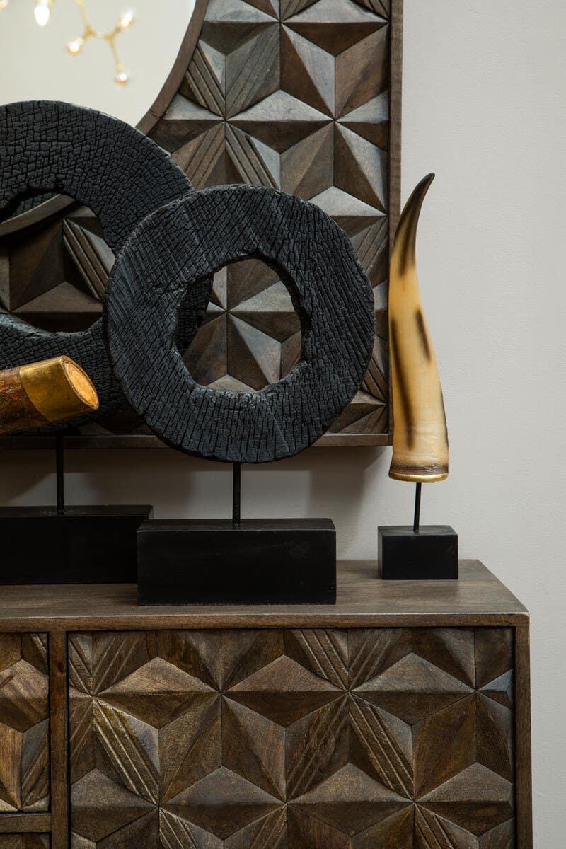 Dark wood sideboard with geometric carved doors and decorative ornaments on top