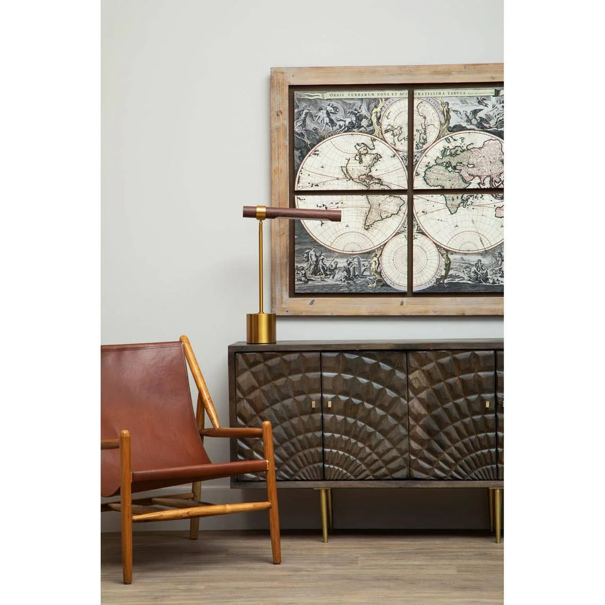 Dark wood sideboard with geometric pattern, leather accent chair, brass table lamp, vintage map