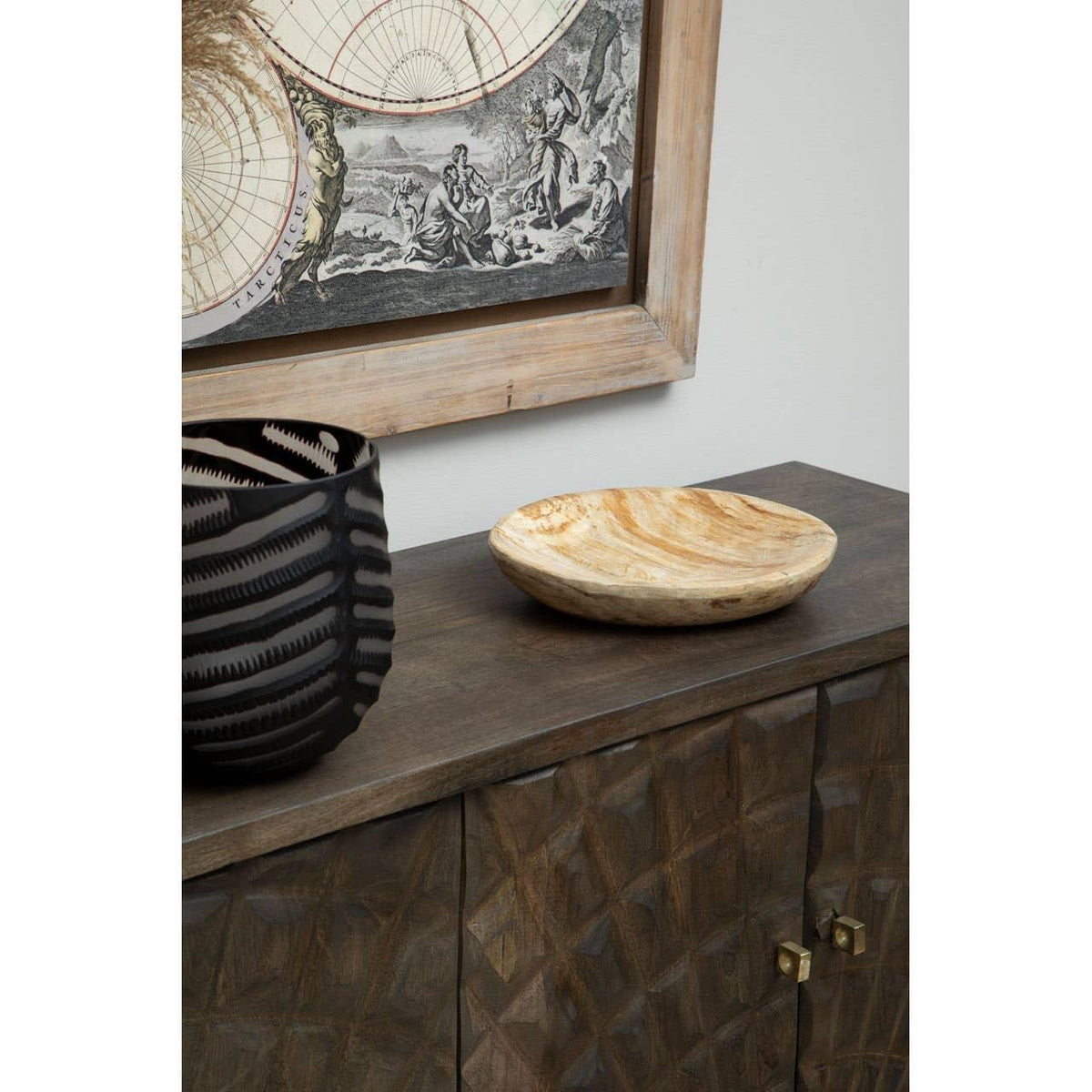 Dark wood sideboard with geometric doors, decorative bowl, and black vase on top