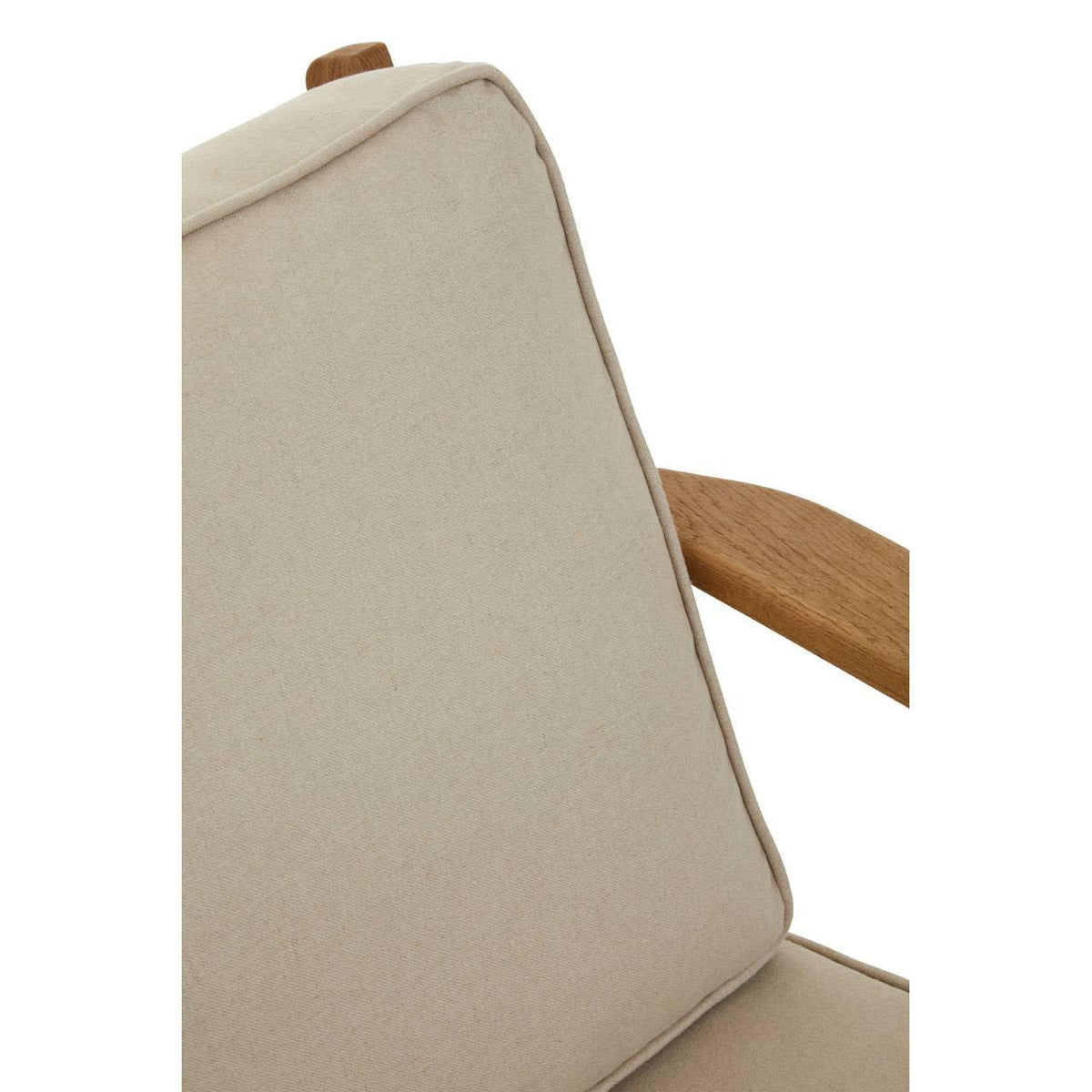 Beige armchair cushion with visible wooden armrest close-up