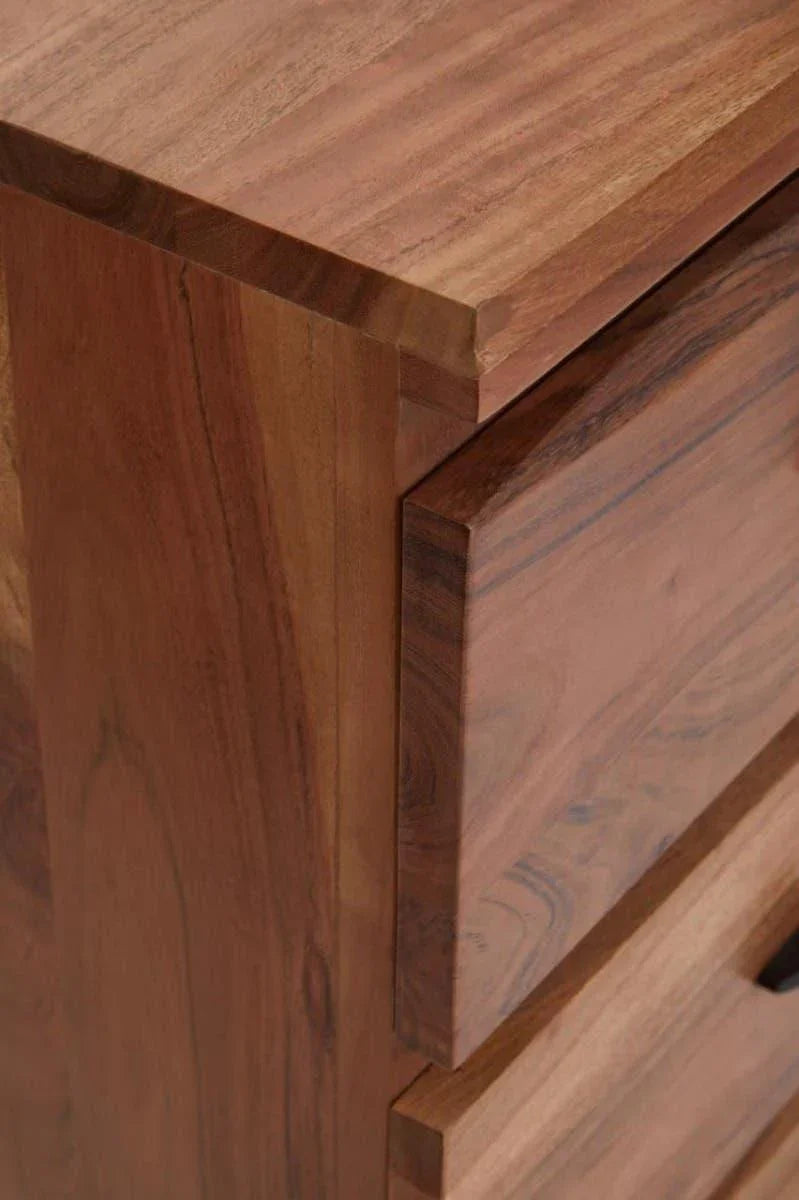 Close view of wooden chest of drawers with natural grain and smooth edges
