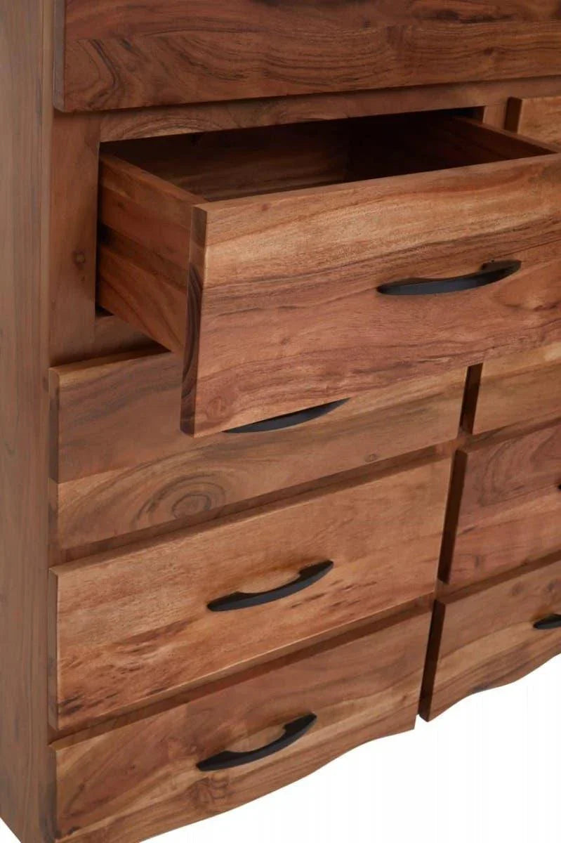 Solid wood chest of drawers with black handles and one drawer partially open