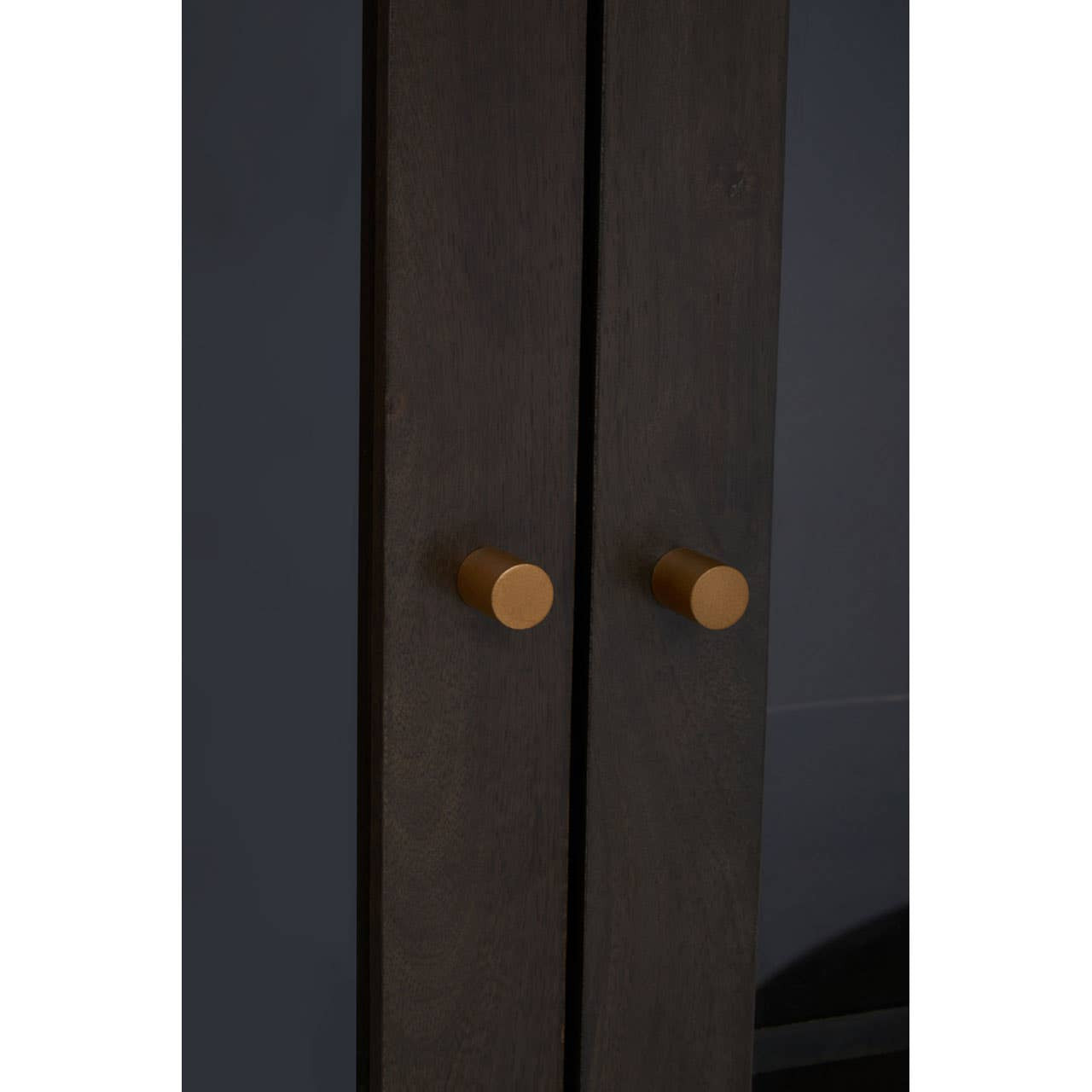 Tall cabinet featuring a grey finish made from mango wood, with two doors and round wooden handles. The cabinet has a sleek design and a minimalist aesthetic, suitable for modern home decor