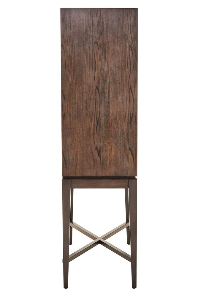 Tall antique grey cabinet with a smooth, flat front and a wooden texture, featuring a simple design and a cross-braced base for stability. The cabinet stands on slender legs, showcasing a minimalist aesthetic suitable for various home decor styles