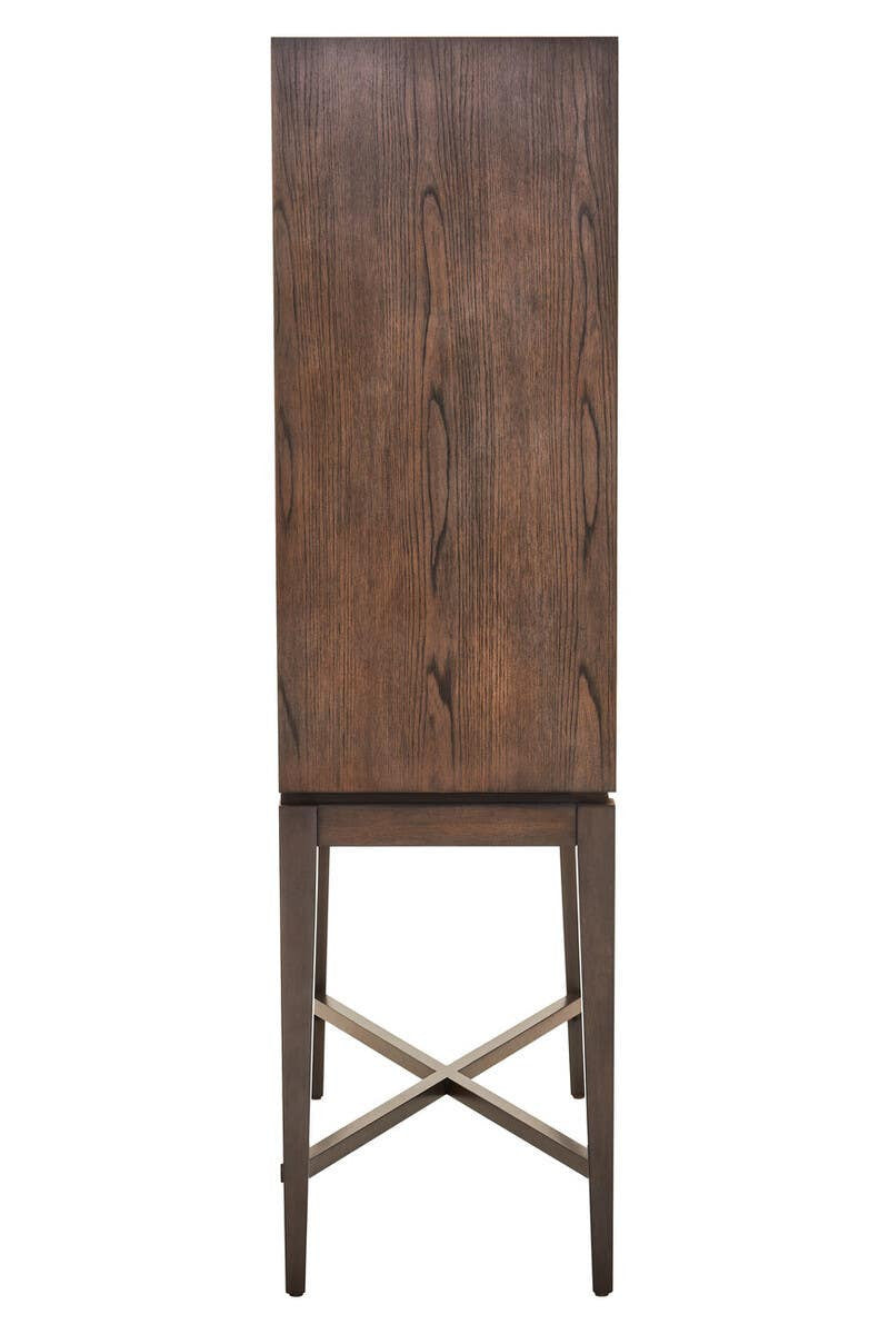 Tall antique grey cabinet with a smooth, flat front and a wooden texture, featuring a simple design and a cross-braced base for stability. The cabinet stands on slender legs, showcasing a minimalist aesthetic suitable for various home decor styles