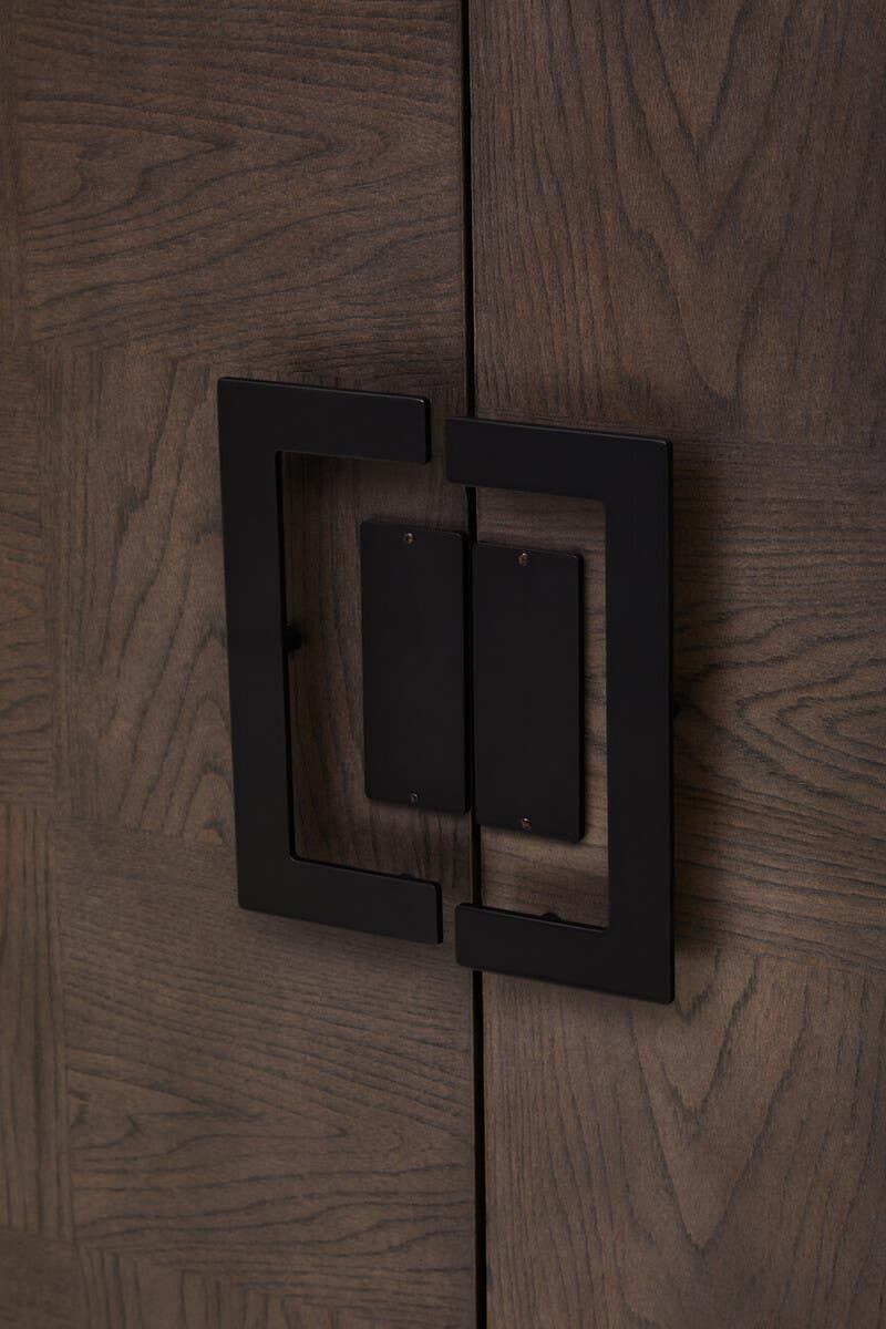 Close-up view of the handle on the Dimaro Antique Grey Cabinet, featuring a square design with a dark metal finish against a textured grey wood surface