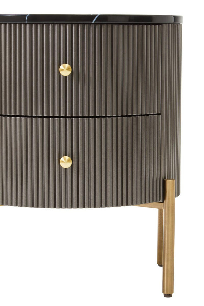 Grey two-drawer chest featuring a black marble top, ribbed texture on the drawer fronts, and gold round handles. The chest stands on slender gold legs, adding a modern touch to the design