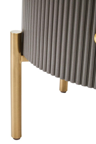 Two drawer chest featuring a grey ribbed body and a sleek black marble top, supported by elegant gold legs. The design combines modern aesthetics with functional storage