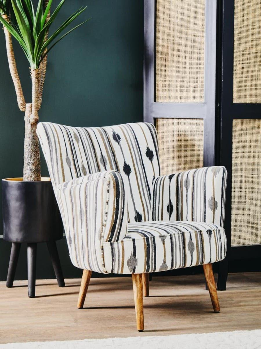 Patterned accent armchair with wooden legs in modern living room setting