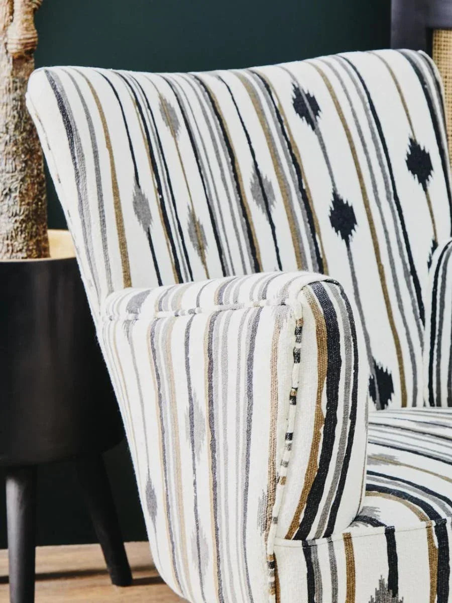 Striped accent chair with geometric pattern upholstery in neutral tones