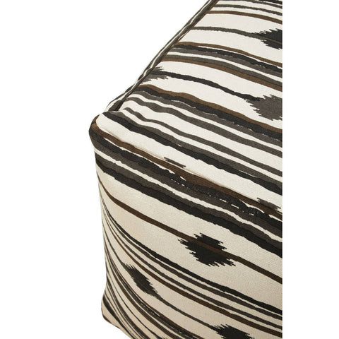 Square pouffe featuring a textured fabric with a black and cream striped pattern, showcasing a corner view that highlights its geometric shape and design details