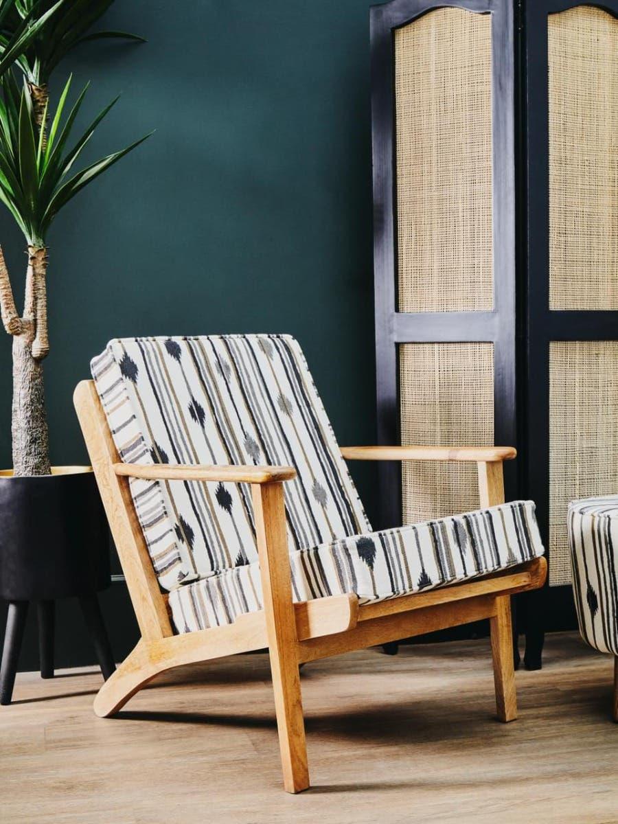 Wooden accent chair with striped cushions in modern living room setting