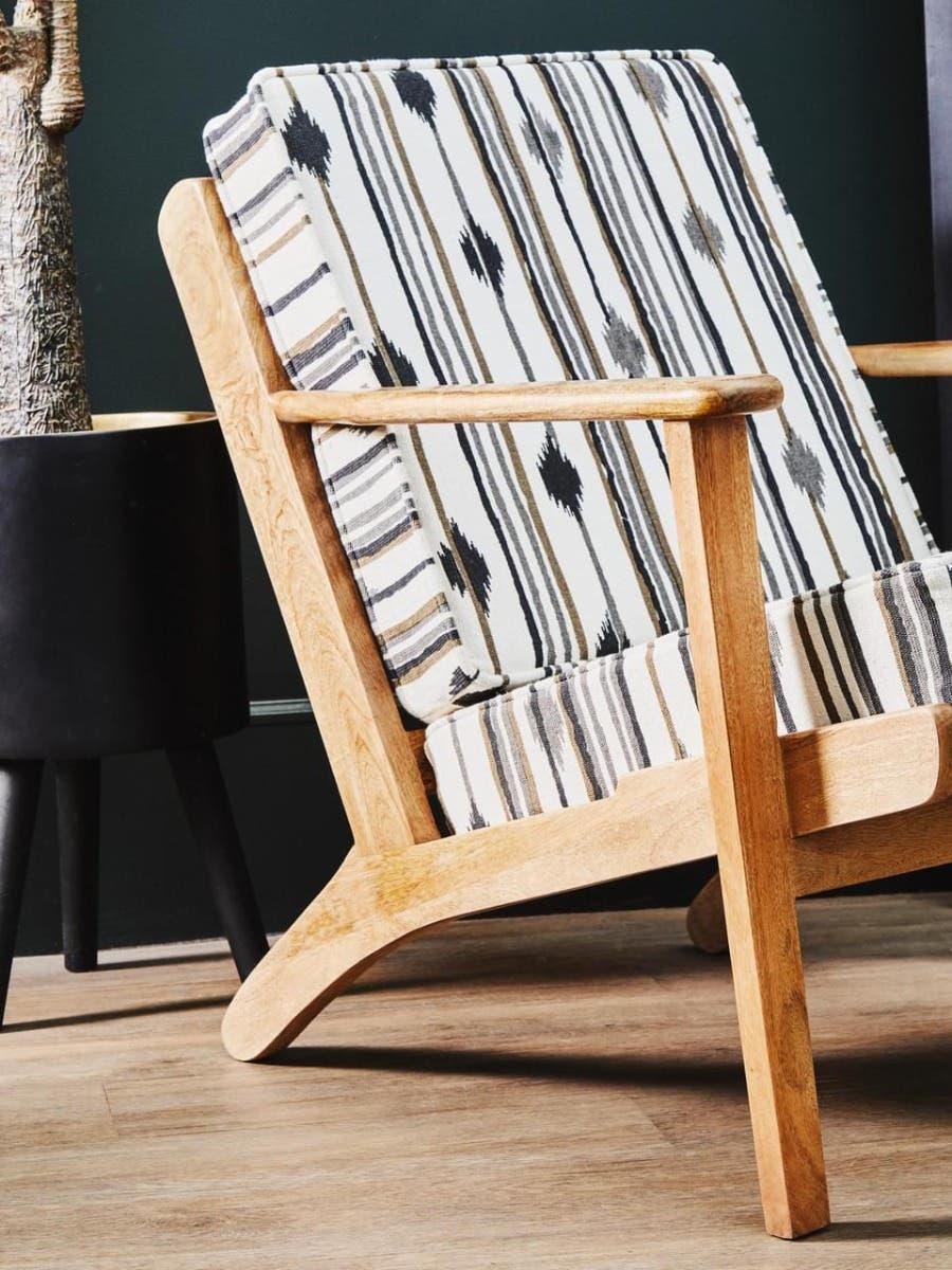 Wooden accent chair with striped patterned cushions in modern living room