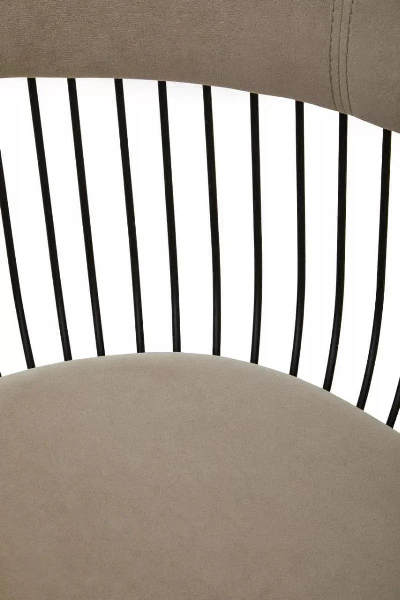 Close up of dining chair with taupe fabric seat and black metal spindle backrest