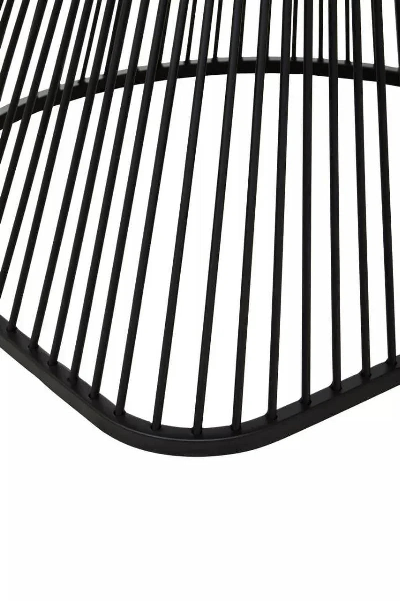 Close-up of black metal dining table base with modern linear design